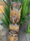 Wooden carved statue with ornate gold headdress and decorative patterns