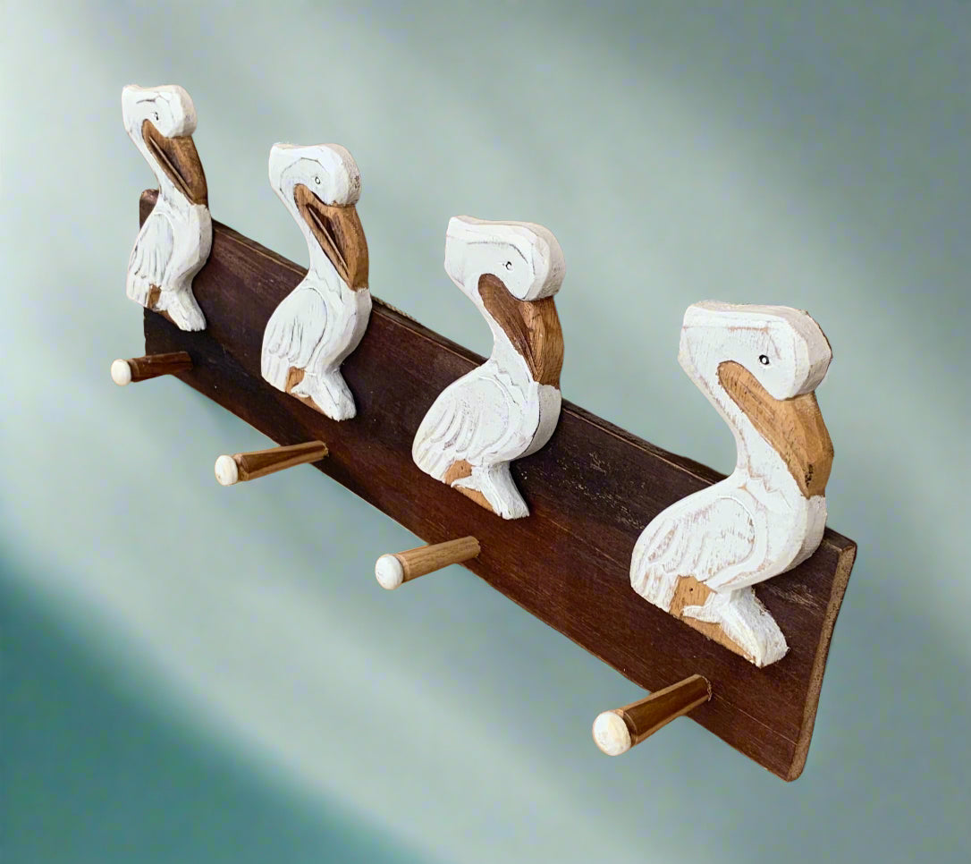 Wooden coat rack with four carved duck figures perched along a dark brown beam.