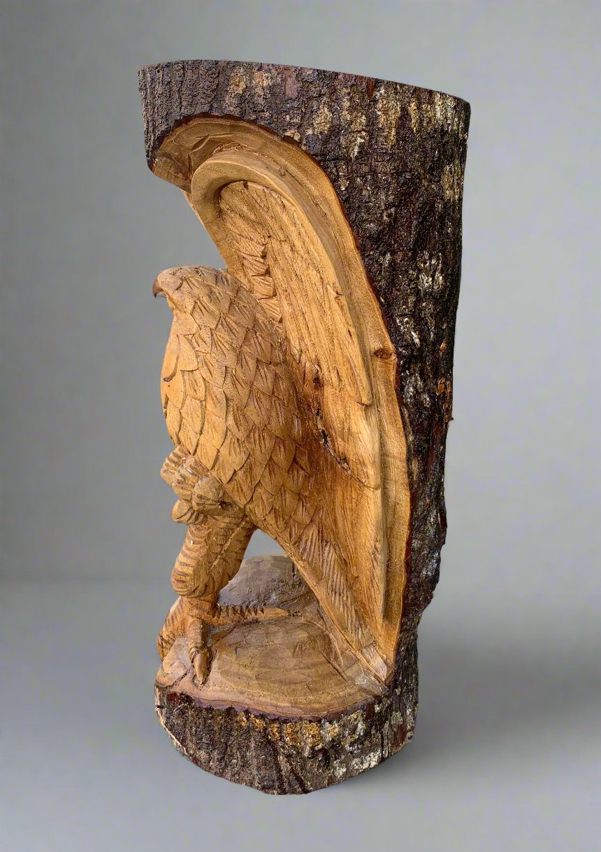 wooden eagle carving on tree trunk with detailed feather texture