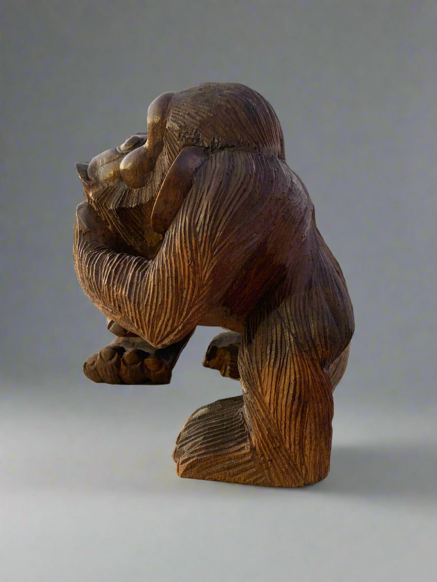 Hand-carved wooden gorilla sculpture with detailed grain texture