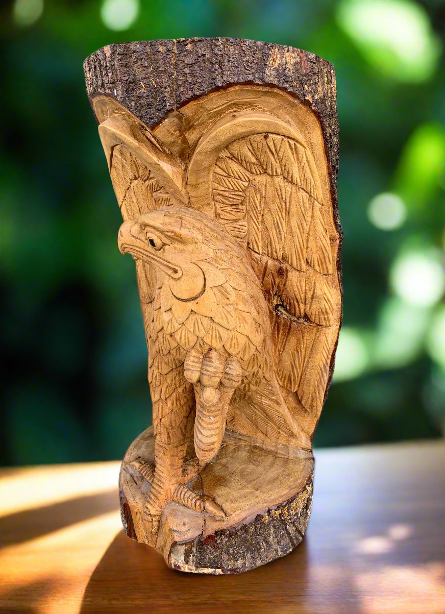 Wooden owl sculpture carved into a tree trunk.