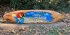 wooden surfboard with colorful parrot and Always Happy Hour sign