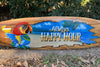 Wooden surfboard sign with parrot and Always Happy Hour lettering