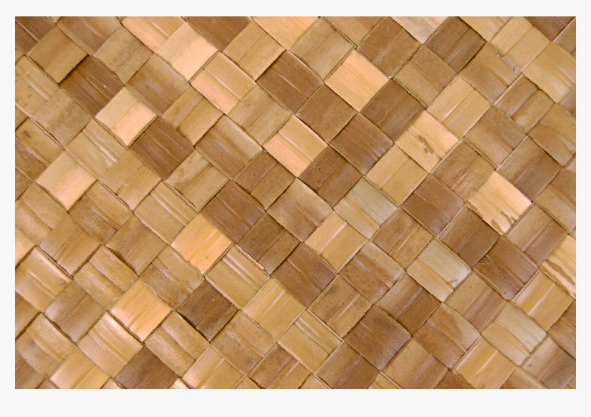 Close-up of a woven bamboo mat with natural brown tones