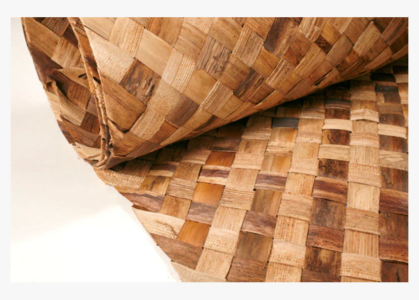 Close-up of a rolled woven wooden mat with a checkerboard pattern