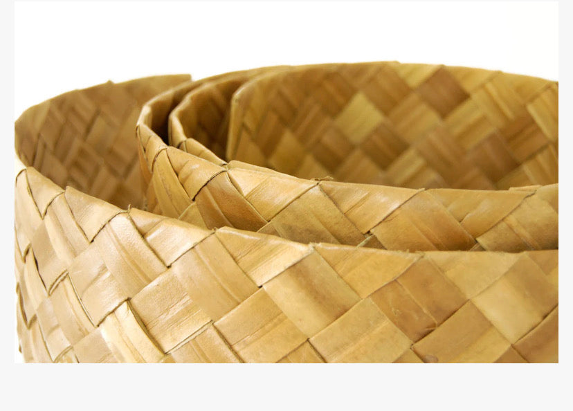 Close-up of a woven straw basket with interlaced rattan strips.