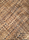 Close-up of a woven wooden pattern with interlaced squares in natural brown tones.