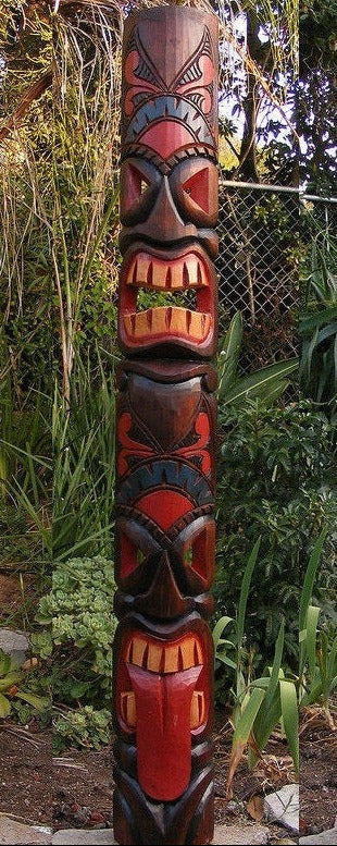 colorful tiki totem pole outdoor carving in a garden