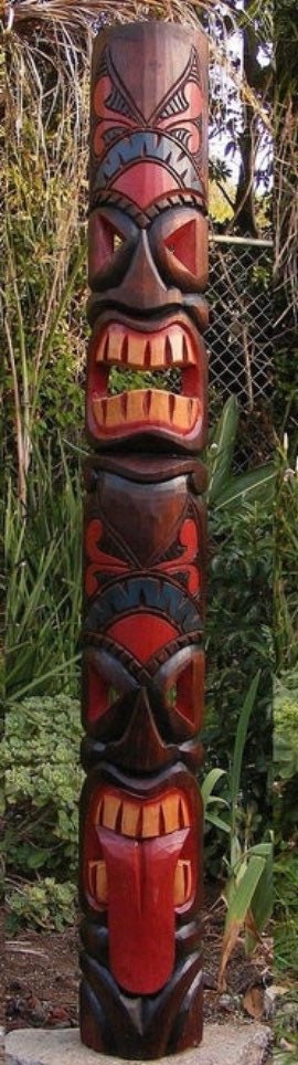 Colorful tiki totem pole with carved faces.
