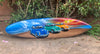 Painted surfboard featuring blue, green, and orange VW Beetle cars on a beach with waves