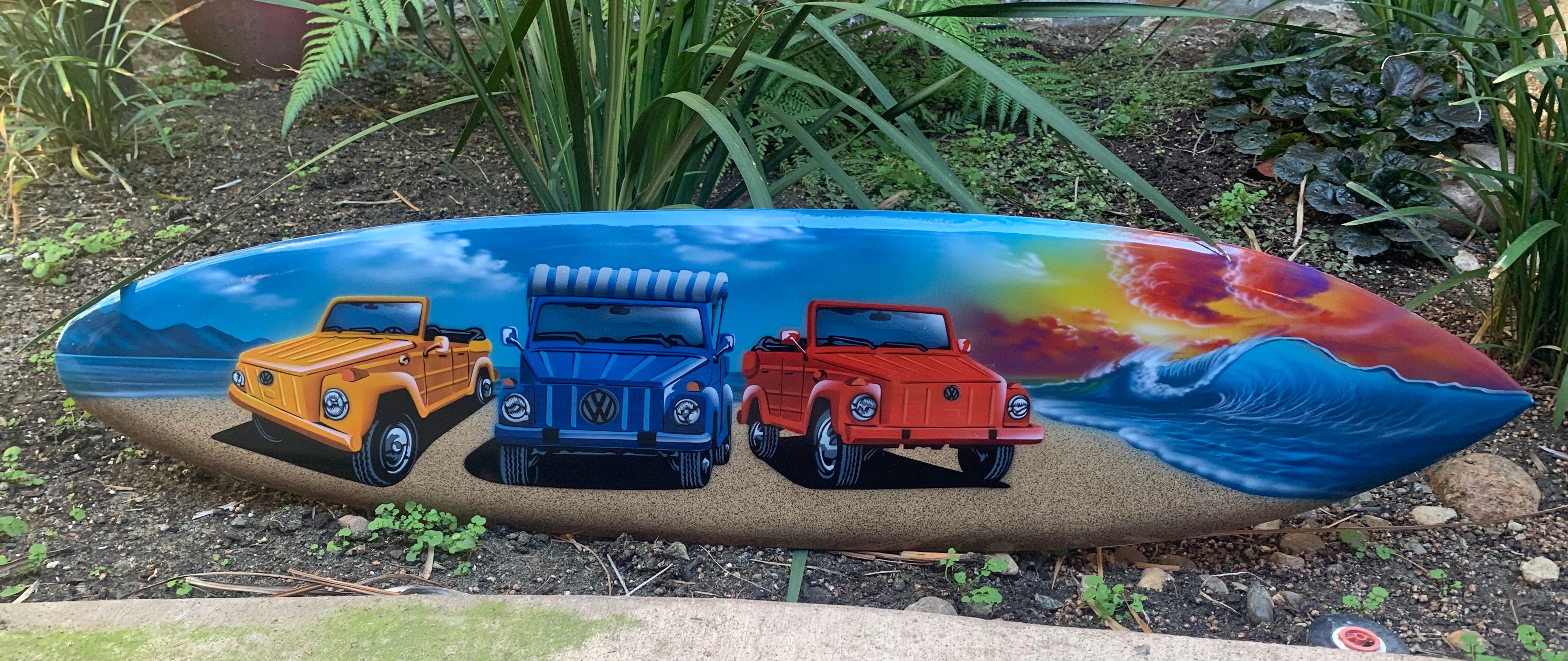 Colorful surfboard painting with yellow, blue, and red vintage VW jeeps on a beach.
