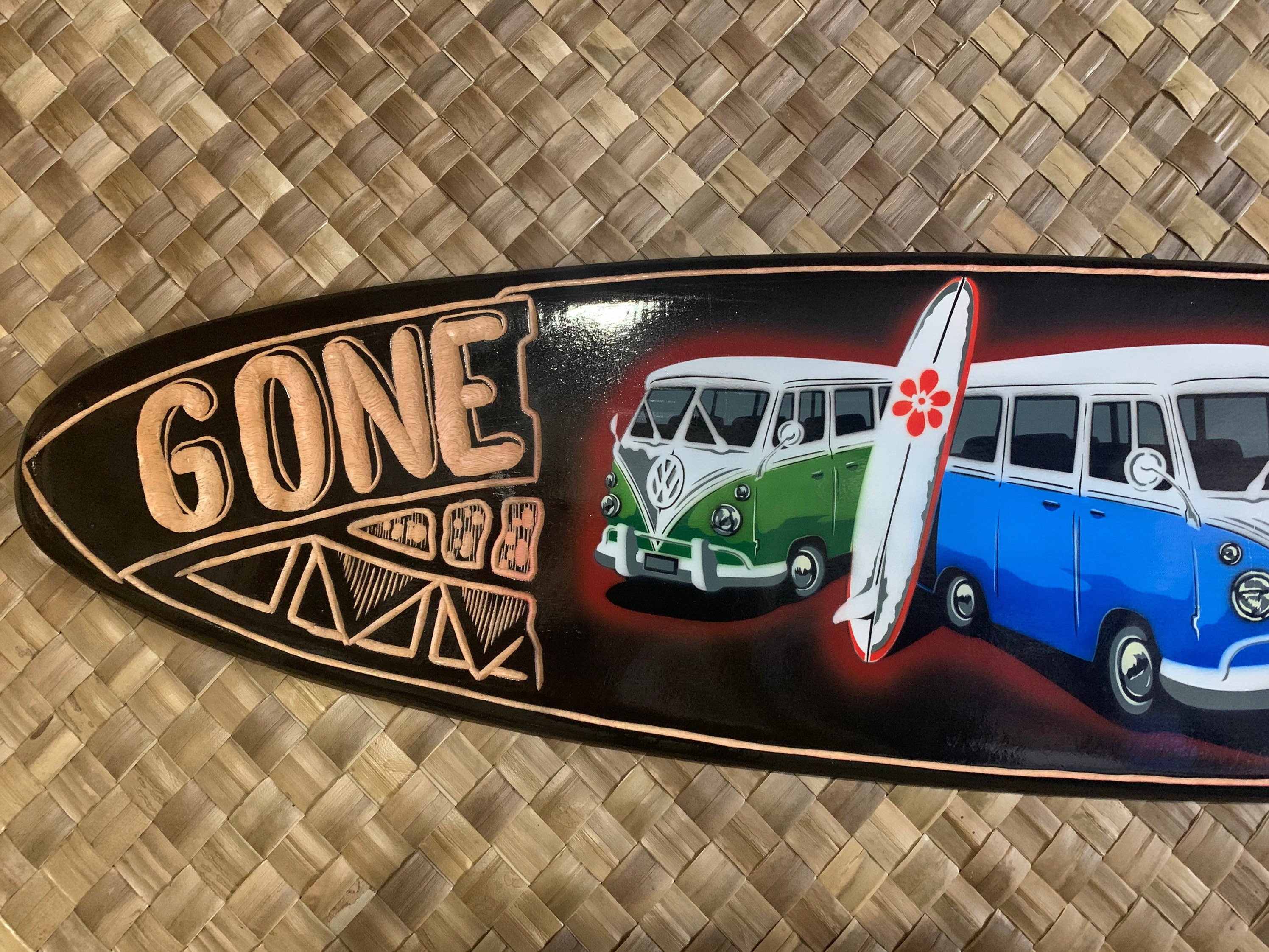 Decorative longboard featuring vintage VW buses and a surfboard graphic with a hibiscus flower.