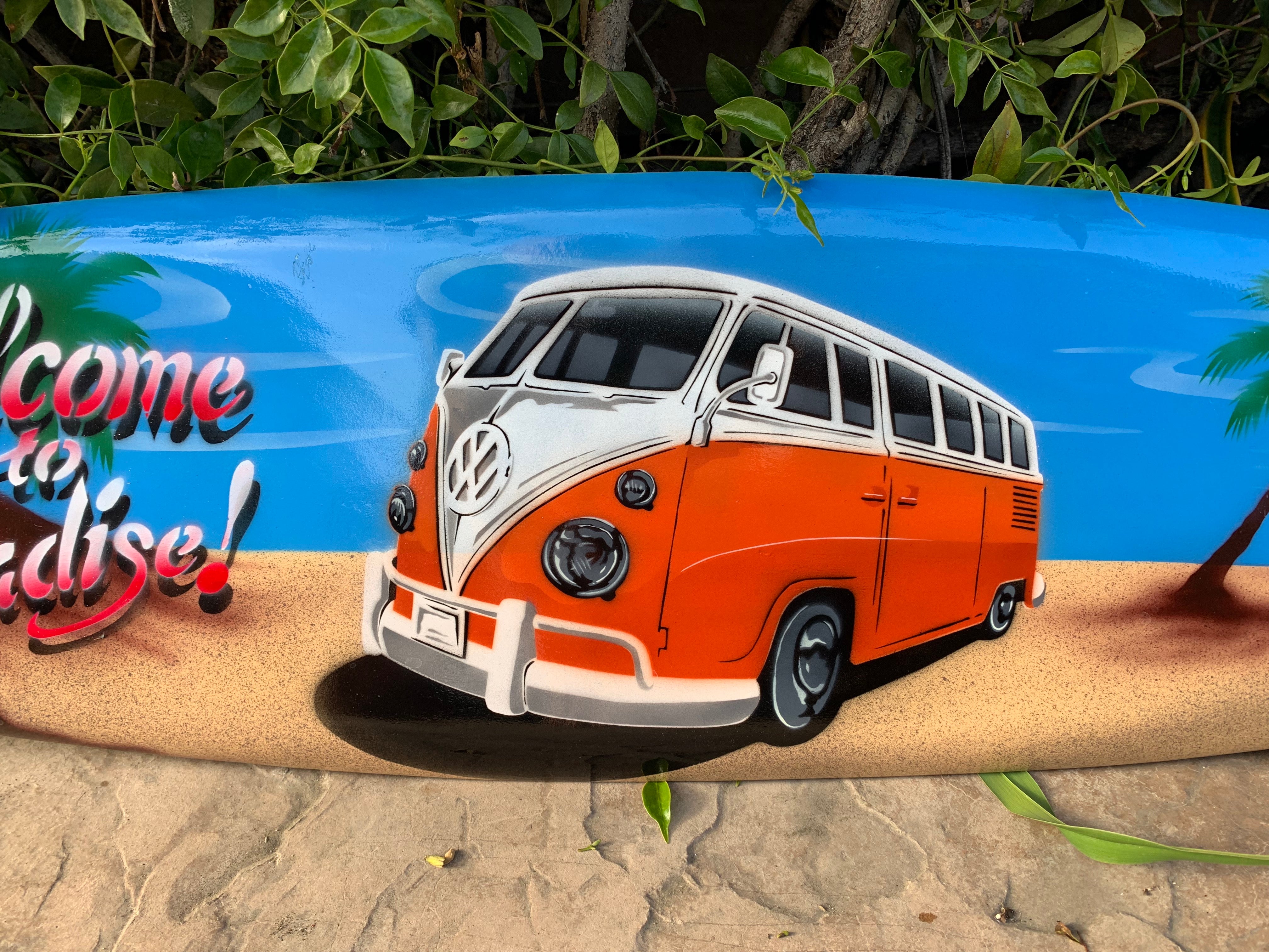 Orange and white vintage VW bus mural on a blue beach banner with palm trees.