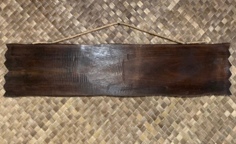 Dark wooden sign plank with rope hanger on woven background