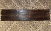 Dark wooden sign plank with rope hanger on woven background