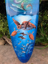 Blue vase with sea turtles and dolphins in an underwater scene.