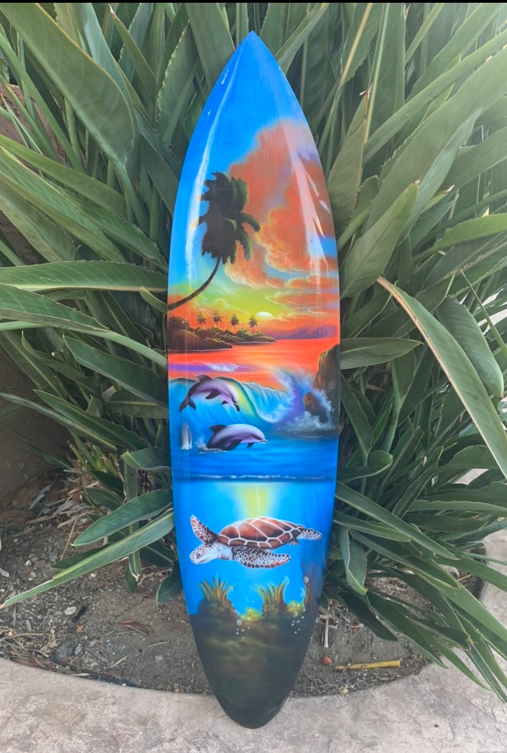 Surfboard with tropical sunset, palm trees, dolphins and a sea turtle